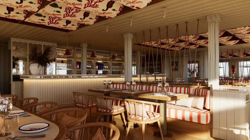 Salle intérieure avec mobilier en rotin, banquettes rayées rouge et blanc, plafond habillé de tissus colorés et bar en fond